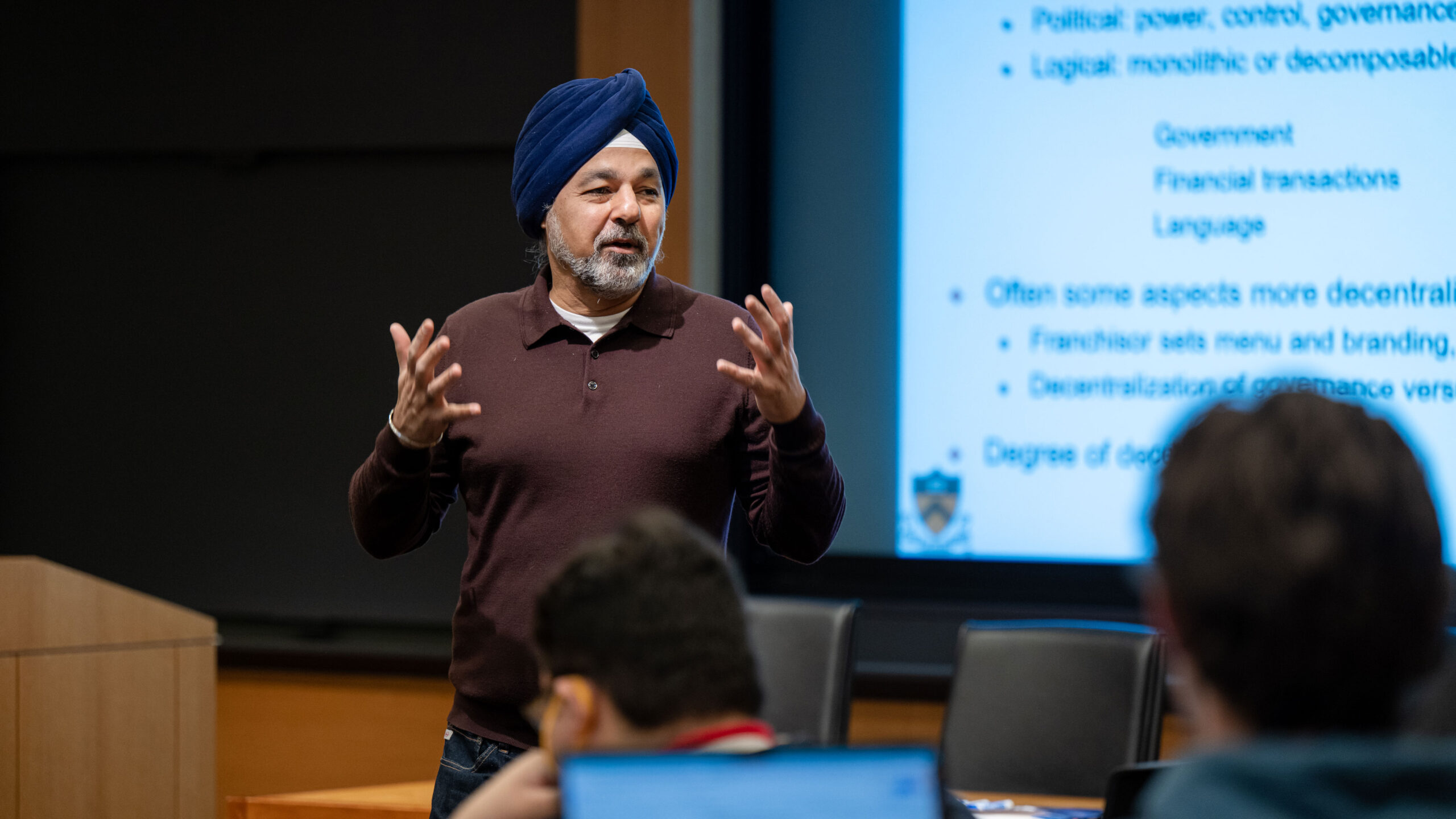 JP Singh teaching a class in front of screen